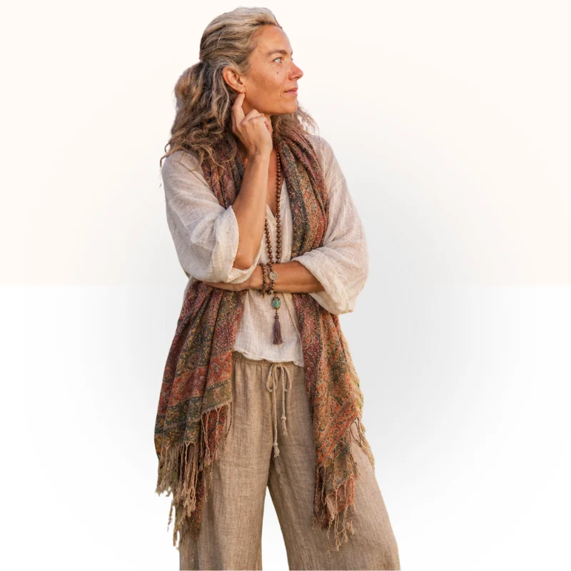 Portrait of D’Arcy Valverde, founder of The Heart Space Center, wearing a patterned scarf and linen clothing